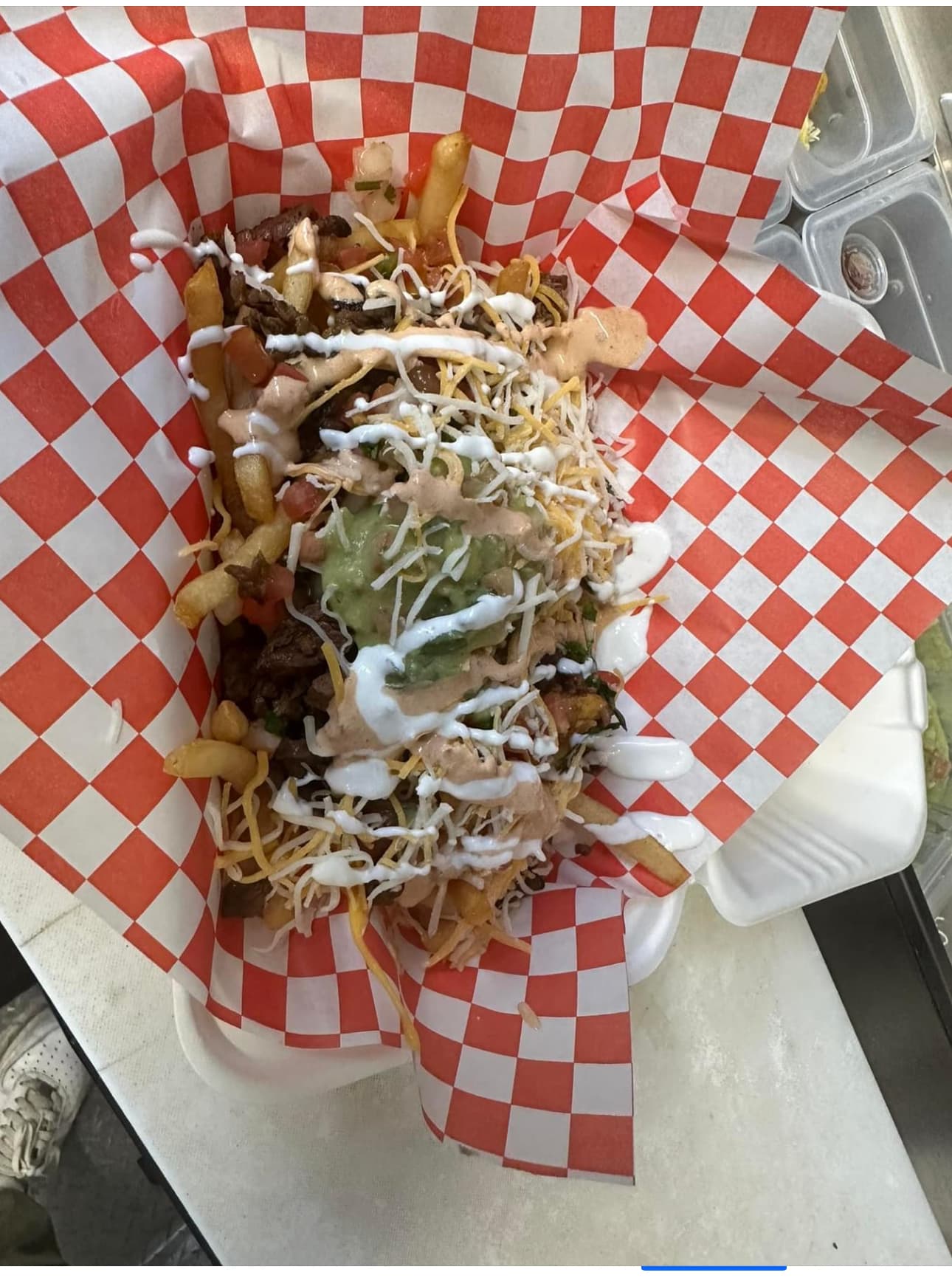 Loaded fries with melted cheese sauce at Dos Tacos Y Mas