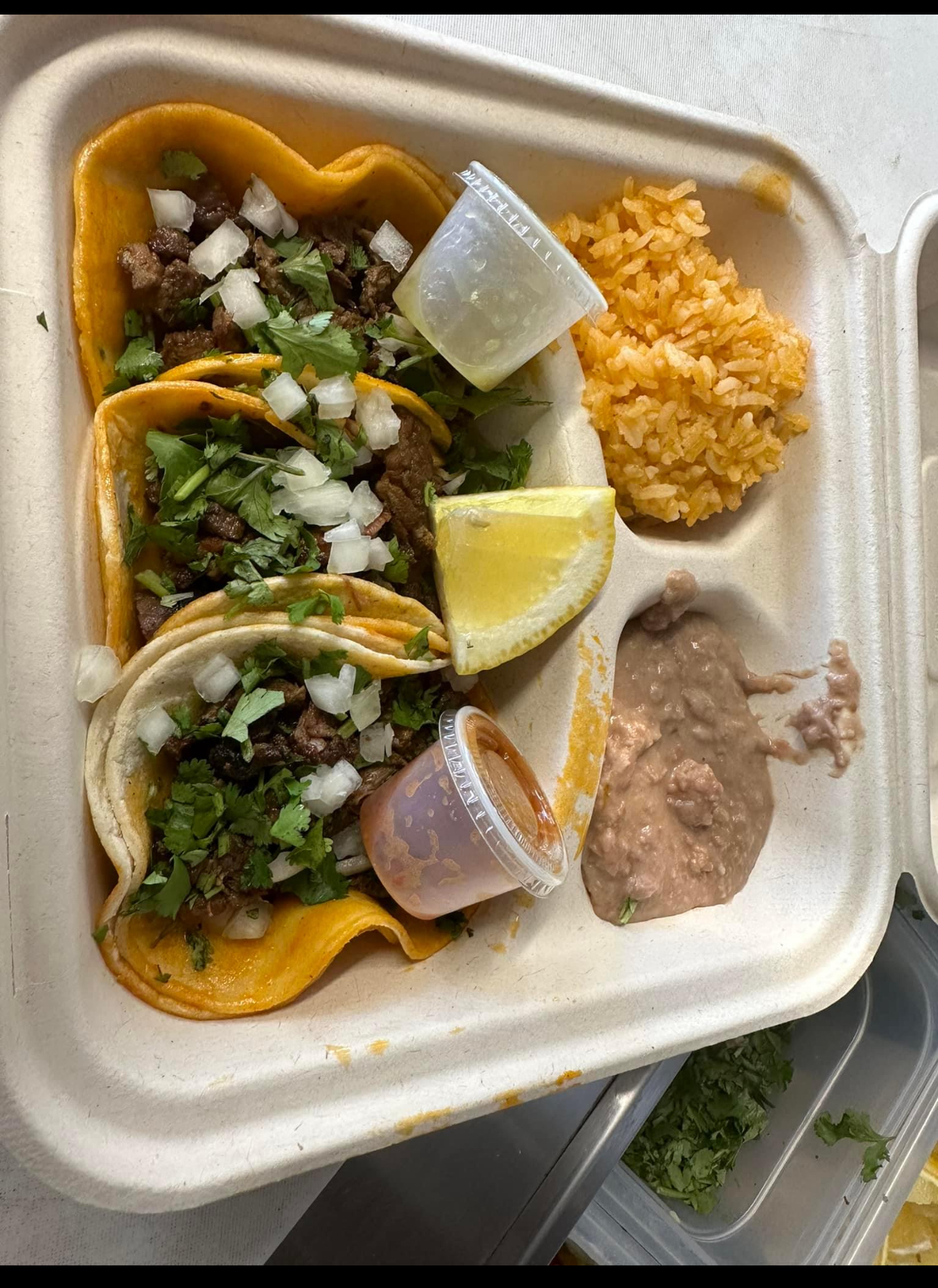 Carne asada tacos and rice plate from Dos Tacos Y Mas, a Sacramento taco truck