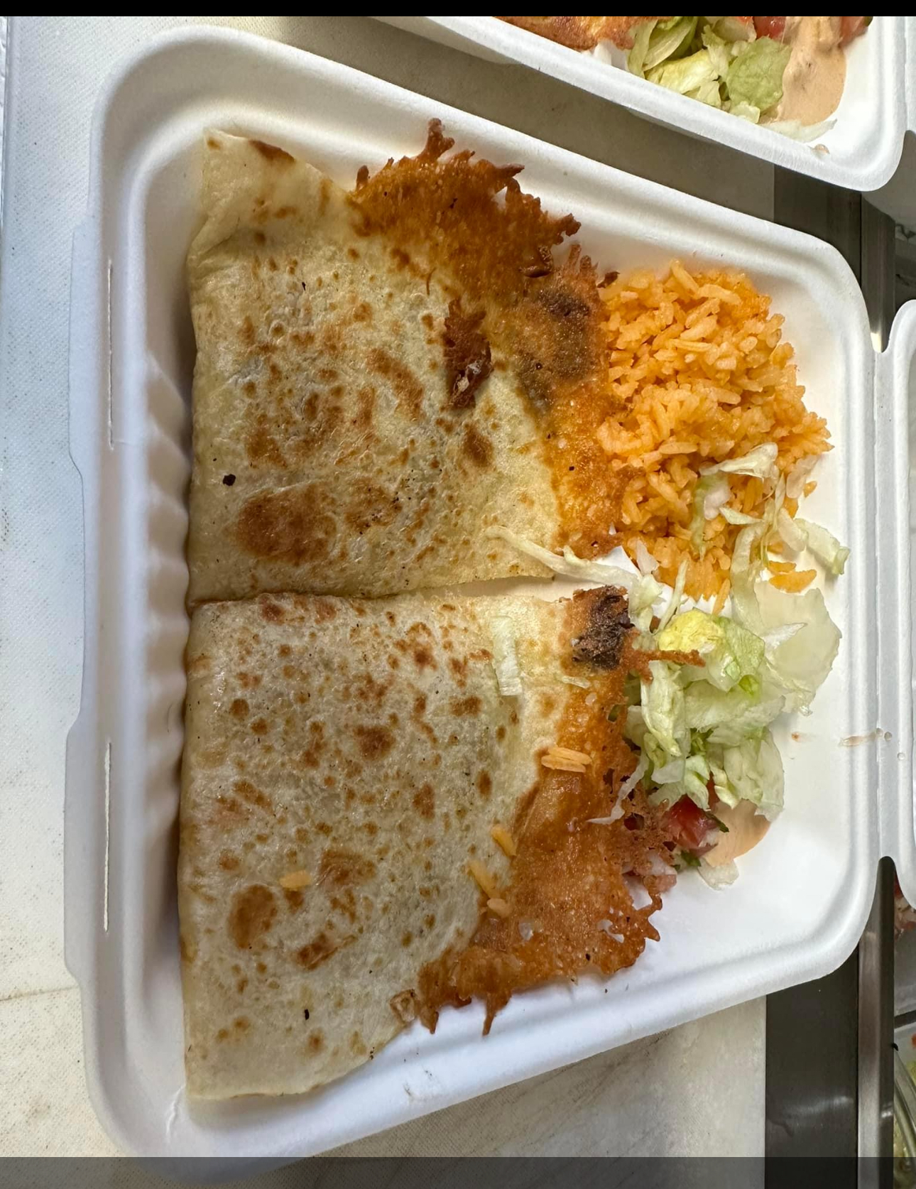 Grilled cheese quesadilla with crispy cheese edges, Mexican rice and fresh salad
